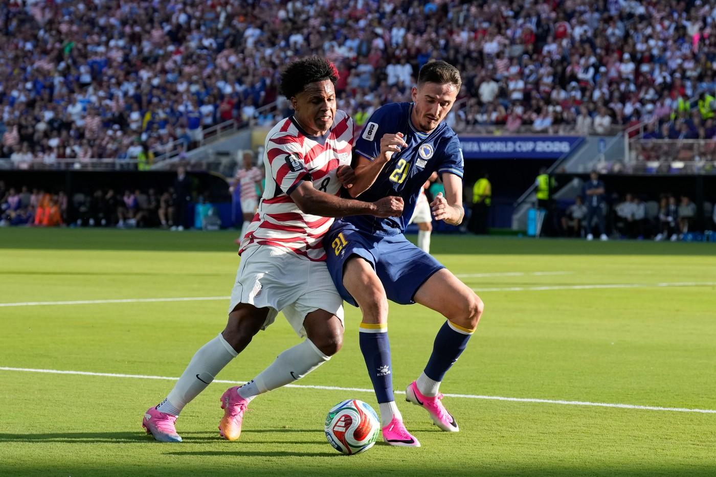 Weston McKennie ze Spojených států (vlevo) a Stjepan Radeljic z Bosny bojují o míč během zápasu 32. kola mistrovství světa ve fotbale